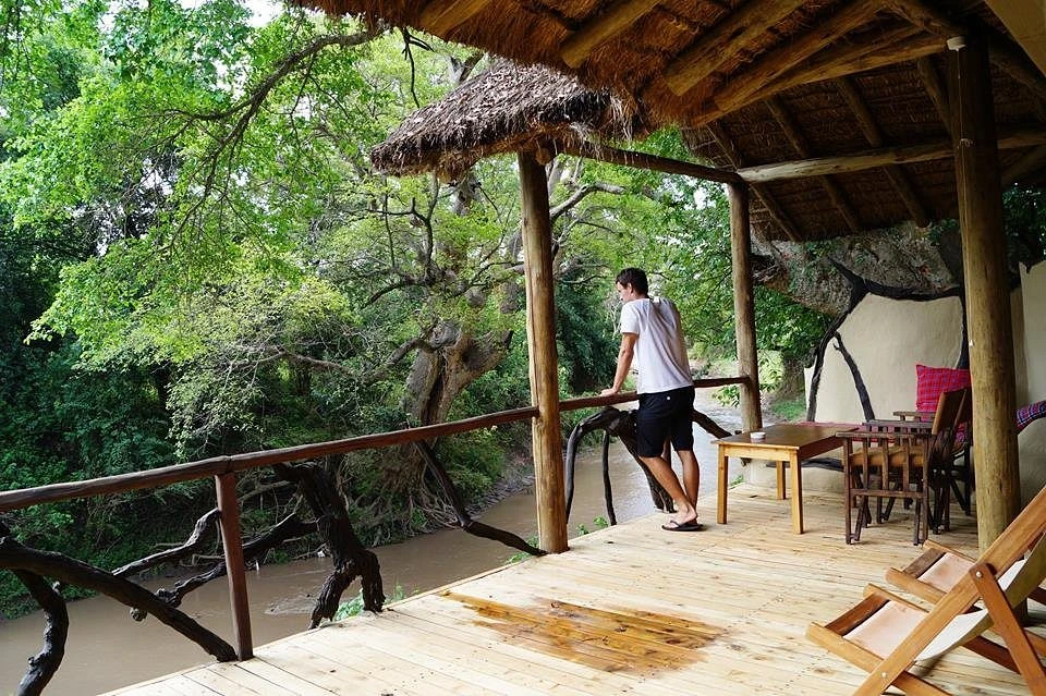 guest enjoying the view of river Talek at Basecamp masai mara